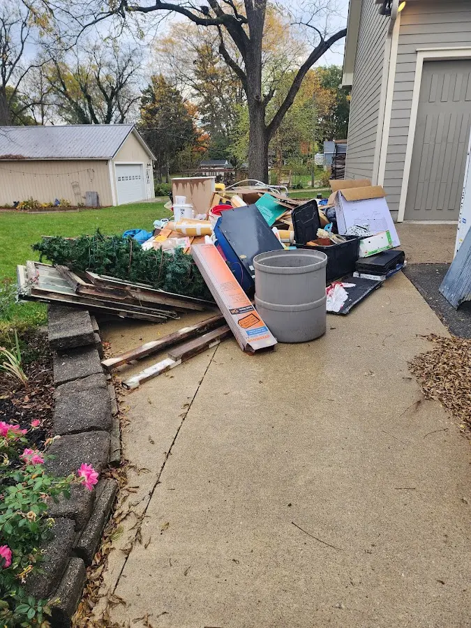 Dumpster being loaded with debris for 12 Yard Dumpster Rental in Monessen